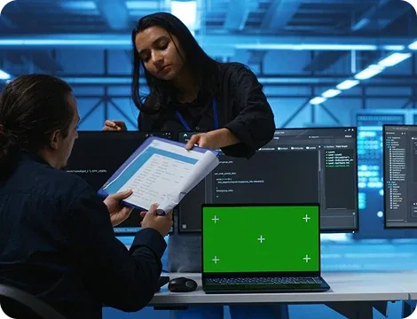 Cybersecurity Team Collaborating in a Server Room with Laptops and Code Analysis
